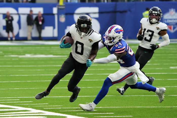 Oct 8, 2023; London United Kingdom, Jacksonville Jaguars wide receiver Calvin Ridley (0) carries the ball against Buffalo Bills cornerback Kaiir Elam (24) during the second half of an NFL International Series game at Tottenham Hotspur Stadium. Mandatory Credit: Kirby Lee-USA TODAY Sports